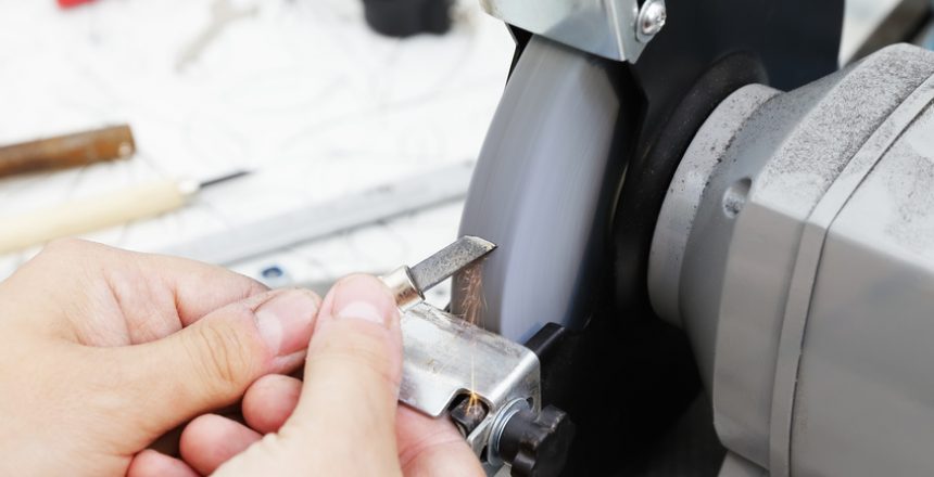 Sharpening the metal cutter on the grinding machine