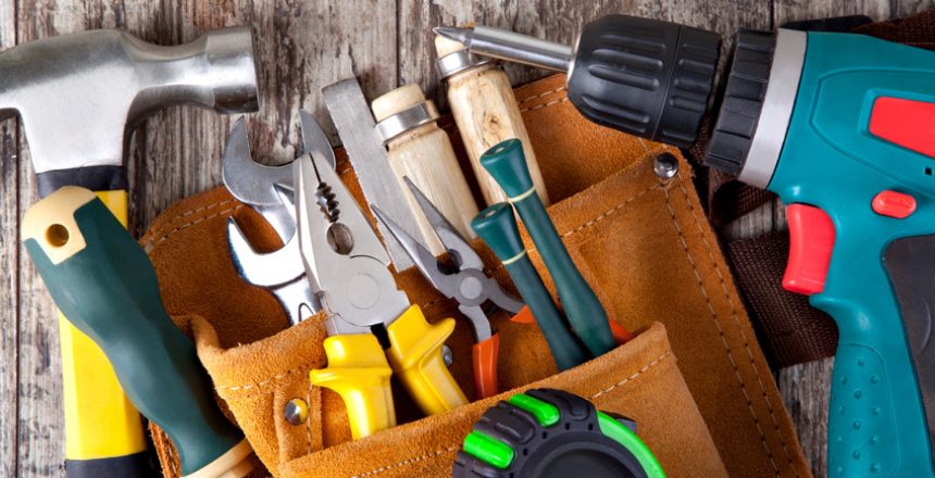 set of tools in tool box on a wooden background